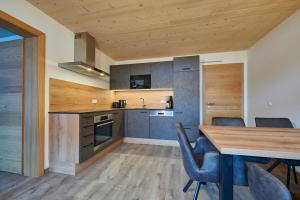 a kitchen with a wooden table and chairs at Appartement Christina in Saalbach Hinterglemm