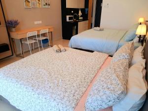 a hotel room with two beds with wedding rings on them at Studio Above The Cloud at Ion Element Genting in Genting Highlands +25 photos