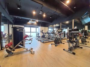 a gym with a bunch of treadmills and machines at Studio Above The Cloud at Ion Element Genting in Genting Highlands