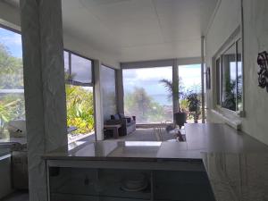 a kitchen with a view of a living room at Taipa Coastal Retreat in Taipa