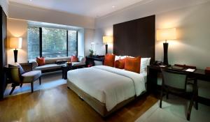 a bedroom with a bed and a desk and a chair at The Saujana Kuala Lumpur in Subang Jaya +61 photos