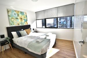 a bedroom with a large bed and a window at Stylish 2 Bedroom APT With CBD View Southbank in Melbourne