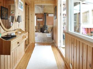 a hallway with wood paneling and a large window at 7 person holiday home in ALLINGSÅS, SVERIGE in Hjälmared