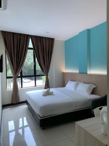 a bedroom with a bed and a large window at M Quality Hotel in Gua Musang