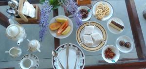 a table with plates of food on it at Near Beach Rest in Unawatuna +45 photos