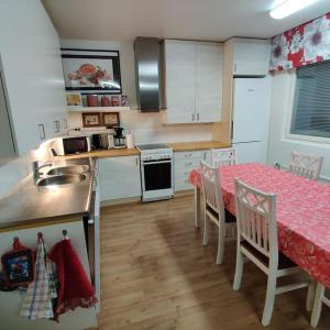 a kitchen with a table and a sink and a table and chairs at Nilsiä city, Tahko, 80 m2, Incude x2 Ski Pass in Tahkovuori