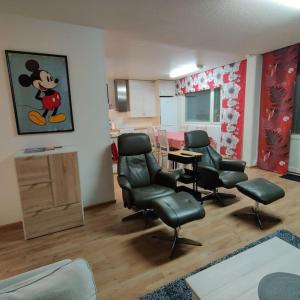 a hair salon with chairs and a mickey mouse painting on the wall at Nilsiä city, Tahko, 80 m2, Incude x2 Ski Pass in Tahkovuori