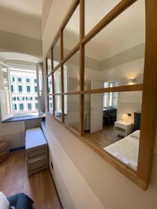 a room with a large window and a bed in it at New Apartament in front of Genoa Cathedral in Genova