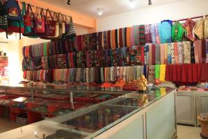 a store filled with lots of different colored ties at Stupa Guest House in Bīr