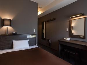 Кровать или кровати в номере Hotel Etwas Tenjin