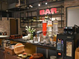 a bar in a restaurant with a bar sign on the wall at Hotel Etwas Tenjin in Fukuoka