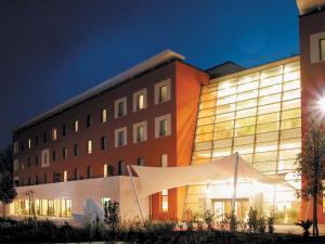 a building with a white tent in front of it at Mercure Genova San Biagio in Genova