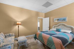 a bedroom with a bed and a chair at Sans Souci unit 706 in Pensacola Beach +58 photos