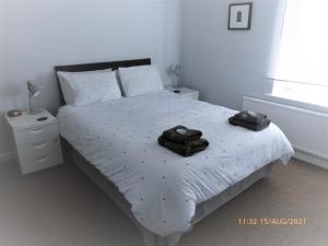 a bedroom with a bed with two towels on it at Marina Cottage, Newark in Newark-on-Trent