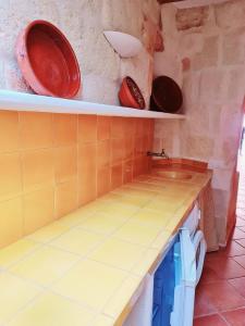 a kitchen with shelves with plates on the wall at Casa Ses Roques in Ciutadella +23 photos