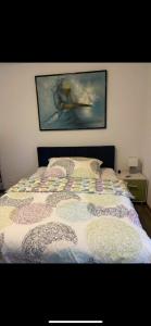 - une chambre avec un lit orné d'une peinture murale dans l'établissement Plein Soleil 1, à Martigny-Ville