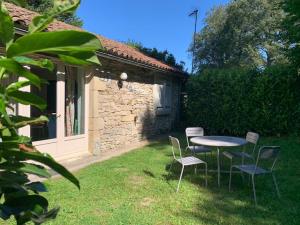 a table and chairs in the yard of a house at Hotel Colombié in Gorses