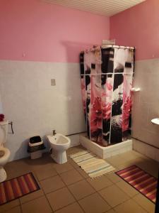 a bathroom with a toilet and a sink at Chez Lilise 3 in Sainte-Anne