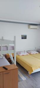 a bedroom with two bunk beds and a table at Top Location in Živogošće