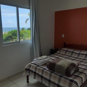 Cama ou camas em um quarto em Apartamento em Imbituba