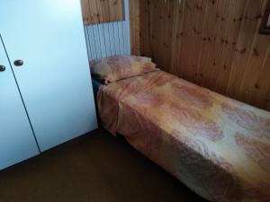 a small bedroom with a bed and a cabinet at Roby in Bosco Chiesanuova