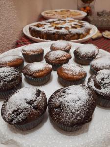 a plate of chocolate muffins with powdered sugar on top at B&B Vignola in Levanto