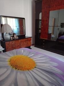 a flower laying on a bed in a bedroom at B&B Angel's in Canosa Sannita