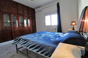 a bedroom with a zebra blanket on a bed at Nice Holiday Apartment Hammam Sousse in Hammam Sousse