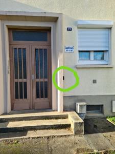 a door leading to a building with a blue door at Private room I in Beauvais