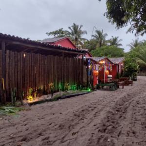 a house on the beach with christmas lights at Pousada Hospedaria Nativus Caraiva in Caraíva +17 photos
