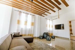 a living room with a couch and a tv at Egyptian Style 5 STAR Villa for Friends and Family Gatherings in 6th Of October