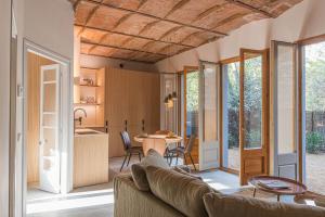 ein Wohnzimmer mit einem Sofa und einem Tisch in der Unterkunft LaComuna City Oasis in Girona