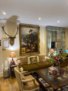 a living room filled with furniture and a fireplace at West Highland Way Hotel in Glasgow