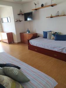 a bedroom with two beds and a flat screen tv at Apartamento estudio Acantilados in Salou