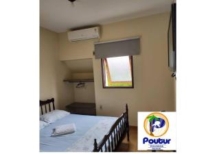 a small bedroom with a bed and a window at Poutur Pousada in Maceió