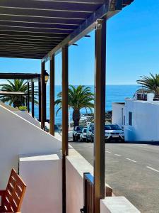 a view of the ocean from a balcony of a house at Luxury Beach Apartments in Playa Honda