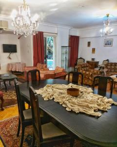 a dining room with a table and a living room at Jessy Charming apartment in Heliopolis in Cairo