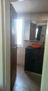 a bathroom with a red sink and a mirror at Lomas de Belgrano in Villa General Belgrano