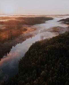 an aerial view of a river with trees at Fish & Fun Holiday Village in Paaso