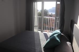 a bed in a room with a large window at APARTAMENTOS AGUAMARINA in Peñíscola +127 photos