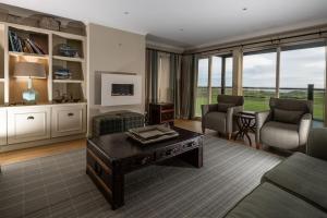 a living room with a couch and a table at Luxurious home overlooking Cruden Bay golf course in Cruden Bay