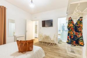 a room with a dress hanging on a rack at Acquazzurra Affittacamere in Tortolì