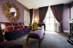 a living room with a purple couch and a mirror at Aurum Royal in Singapore