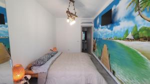 a bedroom with a bed with a painting on the wall at Fly Bed - Milano Malpensa Airport in Cardano al Campo