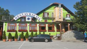 a black car parked in front of a building at Hotel Roškar in Ptuj