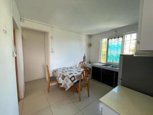 a kitchen with a table and chairs in a room at pereyber 2 room appartment in Pereybere