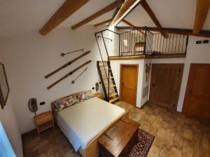 an attic room with a bed and a staircase at BB IL CIPPO in Verona