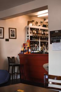 a bar in a restaurant with two chairs and a counter at The Crown and Woolpack in Long Sutton