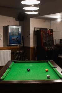 a pool table with a ball on top of it at The Crown and Woolpack in Long Sutton