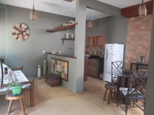 a kitchen with a refrigerator and a table and chairs at Casa hibiscus in Itacaré +26 photos
